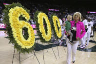 Baylor head coach Kim Mulkey holds her grandson Kannon Reid Fuller as she is congratulated for her 600 wins before an NCAA college basketball game against Oklahoma, Saturday, Feb. 22, 2020, in Waco, Texas. (AP Photo/ Jerry Larson)