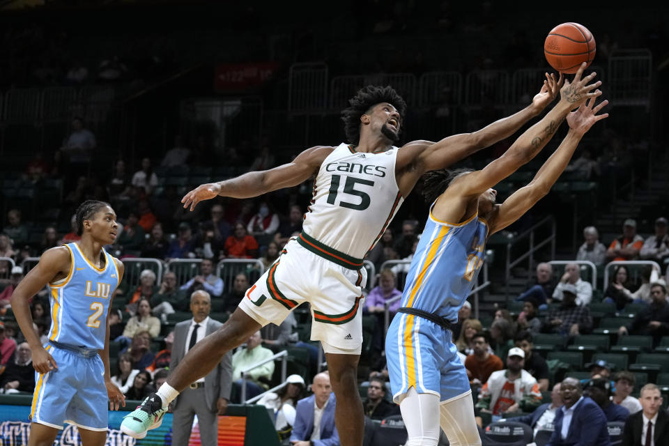 Miami forward Norchad Omier (15) snags a rebound over LIU Brooklyn center CJ Delancy during the first half of an NCAA college basketball game in Coral Gables, Fla., Wednesday, Dec. 6, 2023. (AP Photo/Rebecca Blackwell)