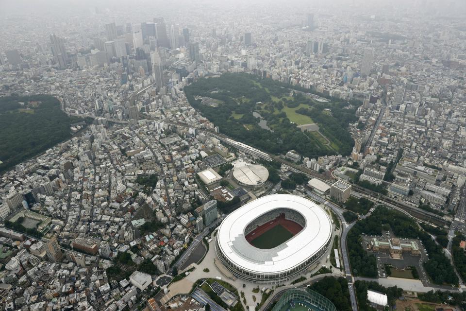 This aerial photo shows the New National Stadium, main stadium for the Tokyo Olympics and Paralympics, in Tokyo, Tuesday, July 21, 2020. The postponed Tokyo Olympics have again reached the one-year-to-go mark. But the celebration is small this time with more questions than answers about how the Olympics can happen in the middle of a pandemic. That was before COVID-19 postponed the Olympics and pushed back the opening to July 23, 2021. (Kyodo News via AP)