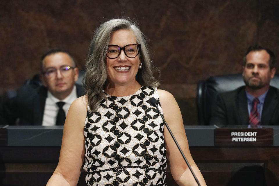 Arizona Democratic Gov. Katie Hobbs smiles prior to delivering the State of the State address at the state Capitol as she is flanked by Speaker of the House Ben Toma, left, R-Glendale, and President of the Senate Warren Petersen, R-Gilbert, Monday, Jan. 8, 2024, in Phoenix. (AP Photo/Ross D. Franklin)