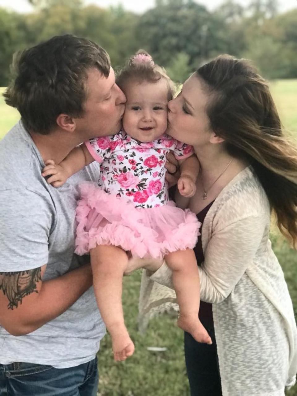 Dustin and Josy Baker with their daughter Lylah when she was about two years old, before she fell ill with melioidosis (Facebook / Josy Baker)