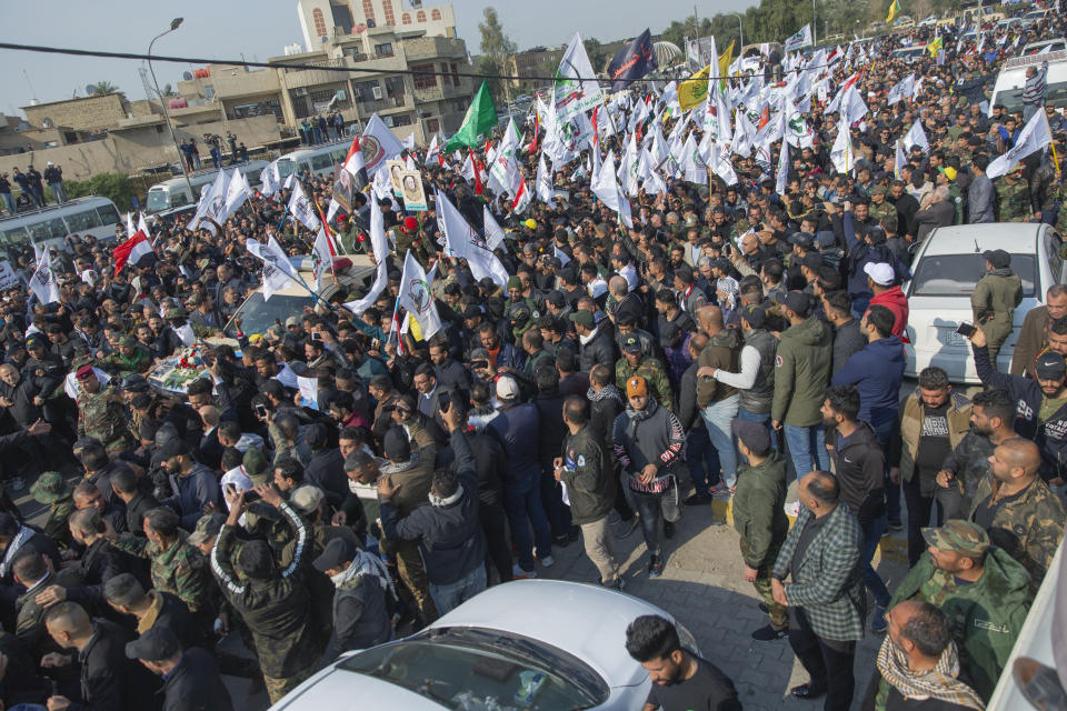 Mourners march during the funeral of Iran's top general Qassem Soleimani, 62, Abu Mahdi al-Muhandis, deputy commander of Iran-backed militias in Iraq known as the Popular Mobilization Forces and fellow militant leaders, in Baghdad, Iraq, Saturday, Jan. 4, 2020. Thousands of mourners chanting "America is the Great Satan" marched in a funeral procession Saturday through Baghdad for Iran's top general and Iraqi militant leaders, who were killed in a U.S. airstrike. (AP Photo/Nasser Nasser)