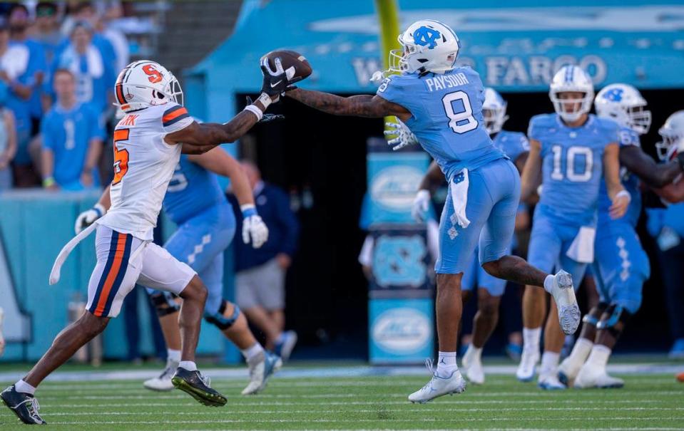 North Carolina’s Kobe Paysour (8) pulls in a pass from quarterback Drake Maye over Syracuse’s Alijah Clark (5) for a 76-yard touchdown to give the Tar Heels’ a 37-7 lead in the third quarter on Saturday, October 7, 2023 at Kenan Stadium in Chapel Hill, N.C.