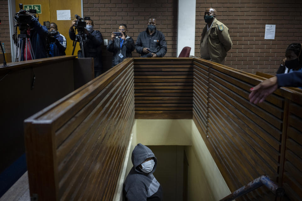 The suspect charged with killing Wandi Zitho waits to enter the courtroom in Vereeniging, South Africa, on Oct. 12, 2020. She was released and the case against her was provisionally dropped because the police didn't deliver enough evidence. Months later, the woman was arrested again and charged with murdering two other children. (AP Photo/Bram Janssen)