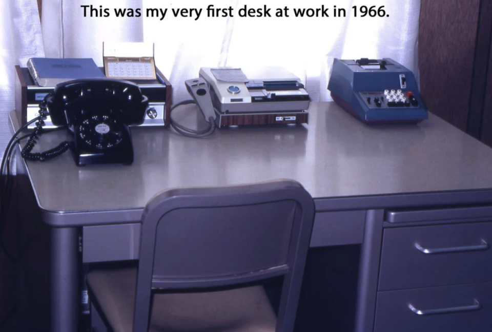 Vintage office desk from 1966 with a rotary phone, typewriter, and telex machine. Text overlay: "This was my very first desk at work in 1966."