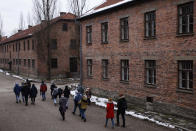 People visit the former Nazi German concentration and extermination camp Auschwitz-Birkenau in Oswiecim, Poland, Thursday, Jan. 26, 2023. Survivors of Auschwitz-Birkenau are gathering to commemorate the 78th anniversary of the liberation of the Nazi German death camp in the final months of World War II, amid horror that yet another war has shattered the peace in Europe. The camp was liberated by Soviet troops on Jan. 27, 1945. (AP Photo/Michal Dyjuk)