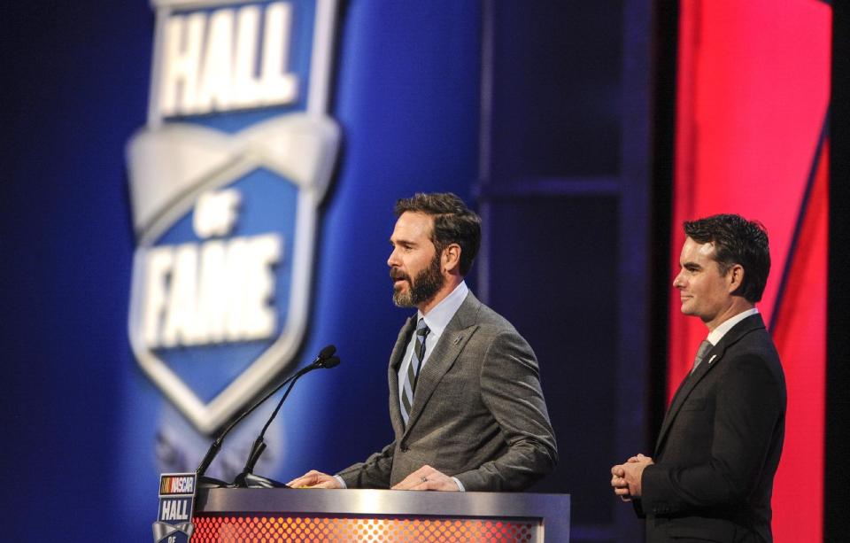 Jimmie Johnson, left, and Jeff Gordon introduce team owner Rick Hendrick during the NASCAR Hall of Fame induction ceremony in Charlotte, N.C., Friday, Jan. 20, 2017. (AP Photo/Mike McCarn)