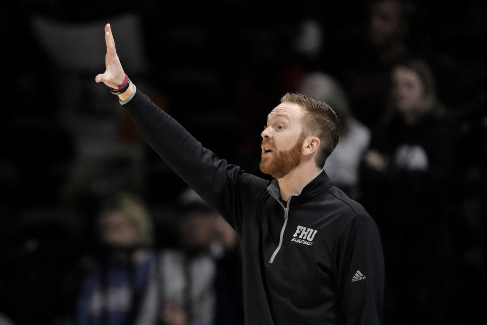 Freed-Hardeman head coach Drew Stutts motions to his players during the first half of the NAIA men's national championship college basketball game against Langston, Tuesday, March 26, 2024, in Kansas City, Mo. (AP Photo/Charlie Riedel)