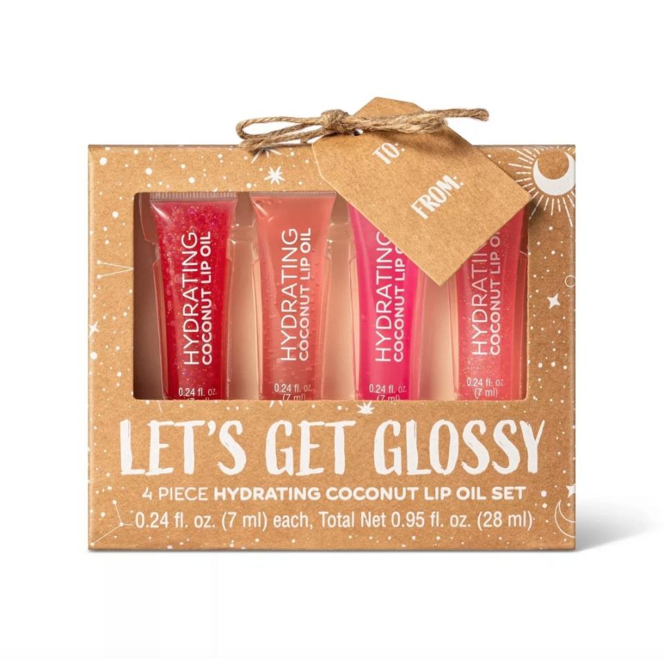 "Let's Get Glossy" tan-colored gift set with four red and pink shades of lip gloss tubes inside