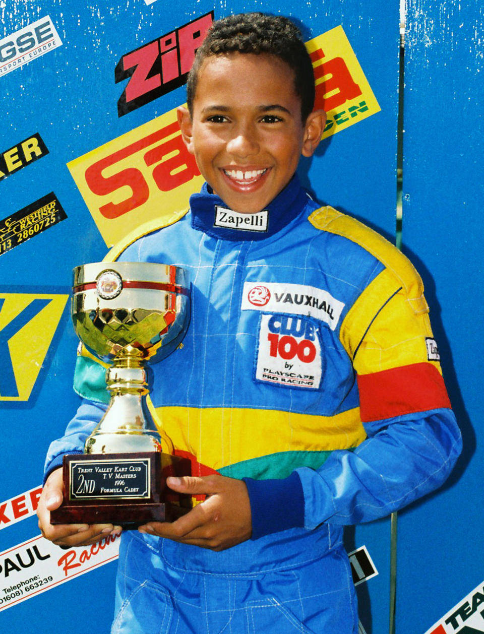 Little boy blue: Lewis Hamilton picks up a Formula Cadet trophy in 1996 – and he’s smiling, even though he came second