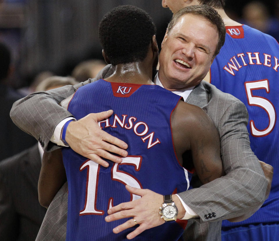 FILE - Kansas coach Bill Self celebrates with guard Elijah Johnson during the second half of the NCAA men's college basketball tournament Midwest Regional final against North Carolina on Sunday, March 25, 2012, in St. Louis. Kansas won 80-67. (AP Photo/Charlie Riedel, File)