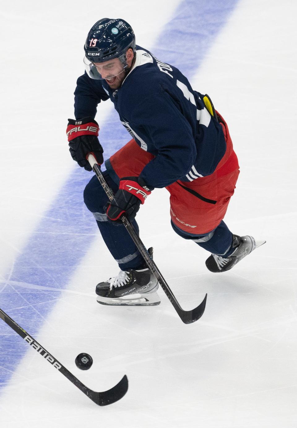 Blue Jackets center Liam Foudy chases the puck during training camp.