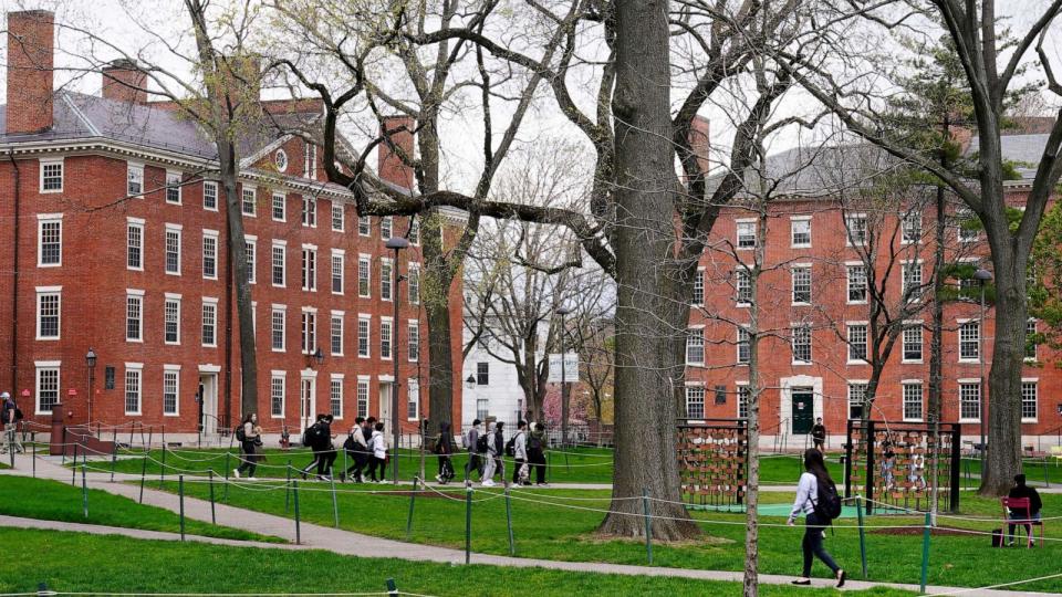 PHOTO: Students walk through Harvard Yard, April 27, 2022, on the campus of Harvard University in Cambridge, Mass. (Charles Krupa/AP)