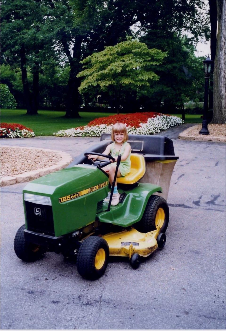 Megan Gegesky, seen here in 1996 on the family tractor at home in Grosse Ile, fell in love with mechanical things early and now plays a key role in the launch of the 2022 Ford F-150 Lightning.