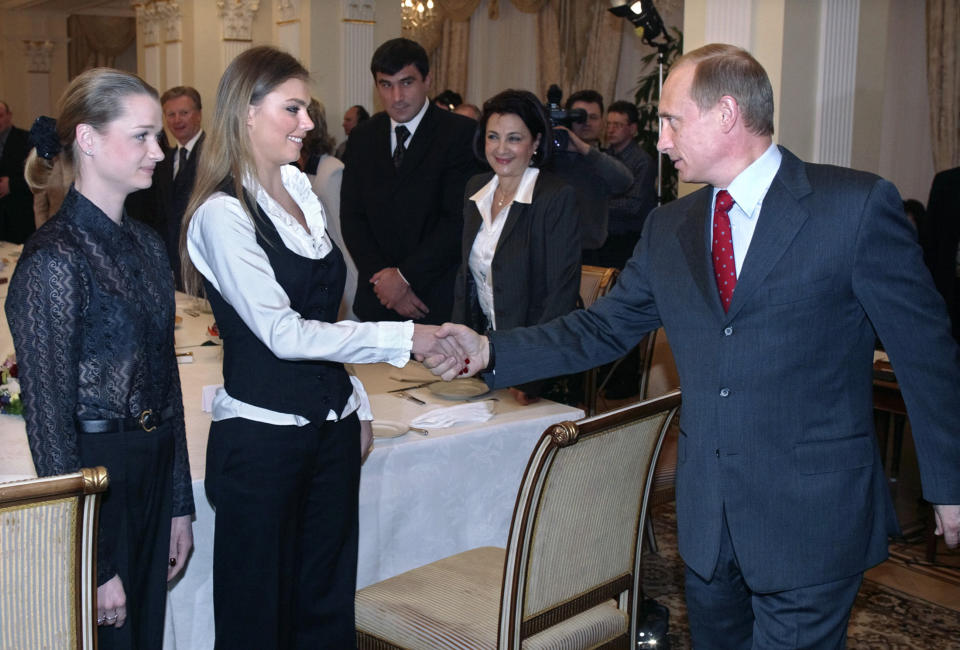 Alina Kabaeva, pictured here shaking hands with Vladimir Putin during a meeting with members of the Russian Olympic team in 2004.