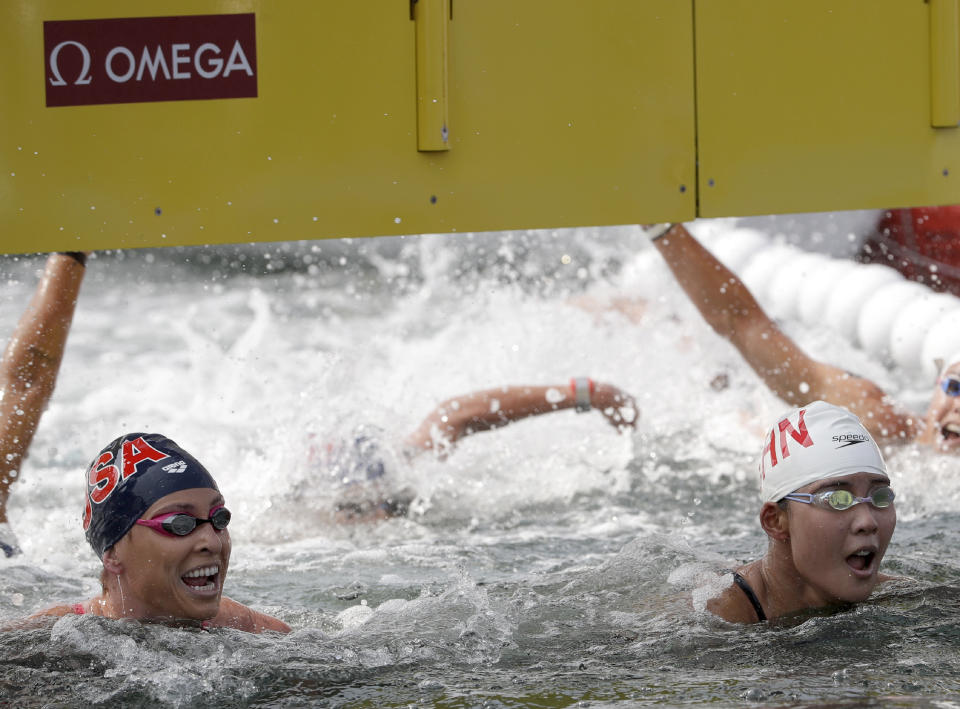 Haley Anderson of the United States, left, and Xin Xin of China react after competing in the women's 10km open water swim at the World Swimming Championships in Yeosu, South Korea, Sunday, July 14, 2019. (AP Photo/Mark Schiefelbein)