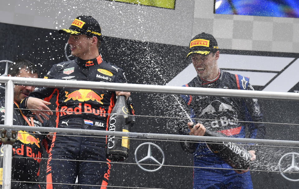 Toro Rosso driver Daniil Kvyat of Russia sprays champagne to the winner Red Bull driver Max Verstappen of the Netherland's, on the podium after the German Formula One Grand Prix at the Hockenheimring racetrack in Hockenheim, Germany, Sunday, July 28, 2019. (AP Photo/Jens Meyer)