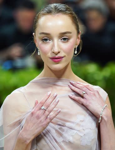 <p>Kristin Callahan/Shutterstock</p> Phoebe Dynevor attends the 2024 Met Gala on May 6, 2024