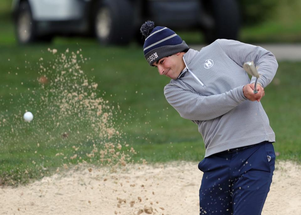 Sam Fauver of Hudson blasts out of the bunker Monday at the Division I district golf tournament at Pine Hills Golf Club in Hinckley