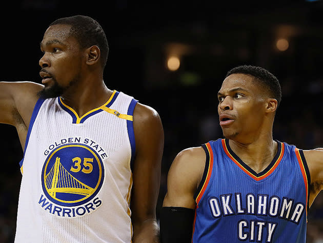 Kevin Durant and Russell Westbrook look in the same direction, point toward different ends. (Getty Images)