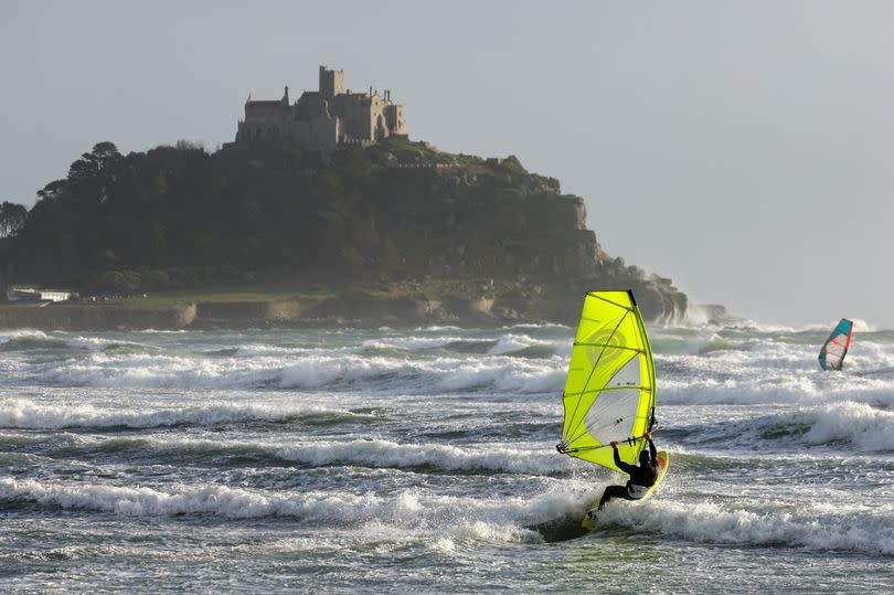 With St Michael's Mount in the background, experienced windsurfers at Marazion take advantage of gusts of up to 70mph from Storm Henk as the Met Office issues an amber weather warning for Cornwall on Tuesday, January 2.