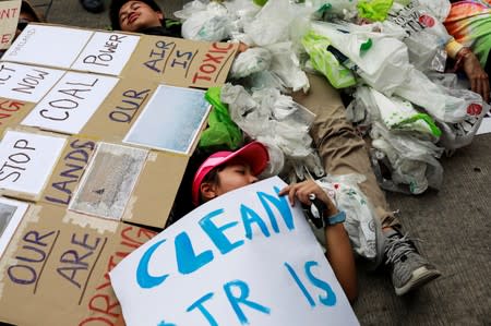 Environmental activist play dead as they participate in a Global Climate Strike near the Ministry of Natural Resources and Environment office in Bangkok