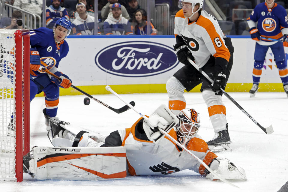 A puck gets past Philadelphia Flyers goaltender Martin Jones (35) for a goal by New York Islanders center Mathew Barzal during the second period of an NHL hockey game, Tuesday, Jan. 25, 2022, in Elmont, N.Y. (AP Photo/Corey Sipkin)