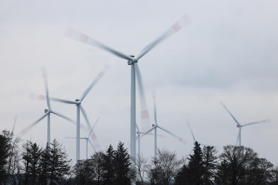 Wind turbines turn at a wind farm in Sprakebuell, Germany, Thursday, March 14, 2024. Sprakebuell is something of a model village for the energy transition - with an above-average number of electric cars, a community wind farm and renewable heat from biogas. All houses in the village center have been connected to the local heating network and all old oil heating systems have been removed. (AP Photo/Frank Molter)