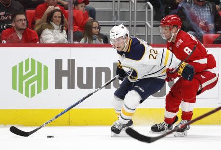 Nov 17, 2017; Detroit, MI, USA; Buffalo Sabres center Johan Larsson (22) gets defended by Detroit Red Wings left wing Justin Abdelkader (8) during the third period at Little Caesars Arena. Raj Mehta-USA TODAY Sports