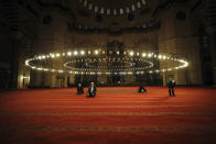 Few face masked people allowed to offer the Eid al-Fitr prayer amid concerns of the coronavirus outbreak at historical Suleymaniye Mosque, in Istanbul, early Sunday, May 24, 2020. Muslims in the world are marking a muted and gloomy religious festival of Eid al-Fitr, the end of the fasting month of Ramadan _ a usually joyous three-day celebration that has been significantly toned down due to the new coronavirus outbreak. (AP Photo/Emrah Gurel)