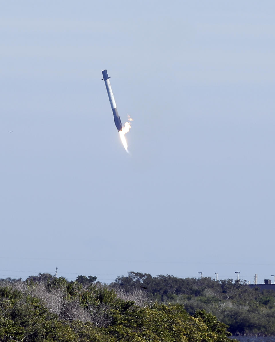 The first stage booster from a Falcon 9 rocket experiences a control problem during its descent, landing in the Atlantic Ocean just east of the launch site instead of a landing zone at the Cape Canaveral Air Force Station in Cape Canaveral, Fla., Wednesday, Dec. 5, 2018. (AP Photo/John Raoux)