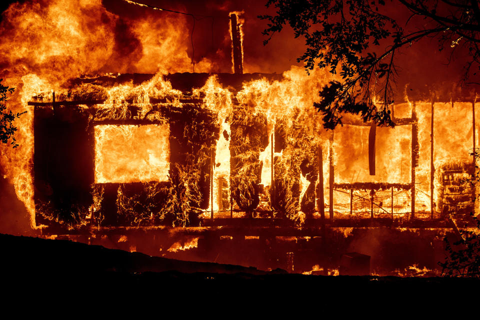 Flames consume a home as the Kincade Fire tears through the Jimtown community of Sonoma County, Calif., Oct. 24, 2019. (AP Photo/Noah Berger)