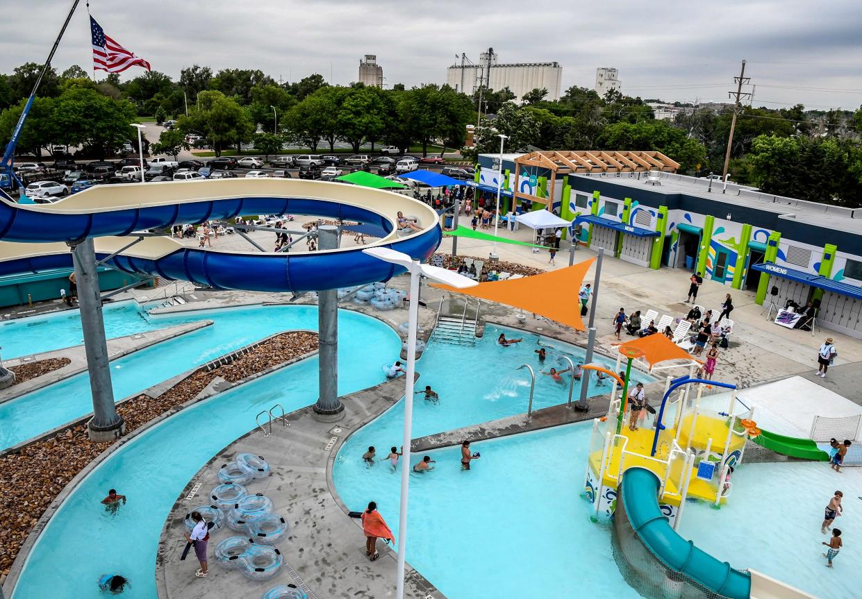 Savannah Wilson, 13 heads down the blue slide as other area residents enjoy various parts of Garden Rapids at the Big Pool during the facility's inaugural summer season.  The Garden City pool has received recognition for its innovations.