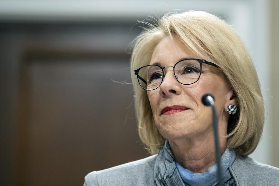 FILE - In this Thursday, Feb. 27, 2020, file photo, Education Secretary Betsy DeVos pauses as she testifies on Capitol Hill in Washington, during a hearing of the House Appropriations Sub-Committee on Labor, Health and Human Services, Education, and Related Agencies on the fiscal year 2021 budget. The federal government has decided to delay changing the way it determines funding for rural education after a bipartisan group of lawmakers said the move would hurt hundreds of schools. (AP Photo/Alex Brandon, File)