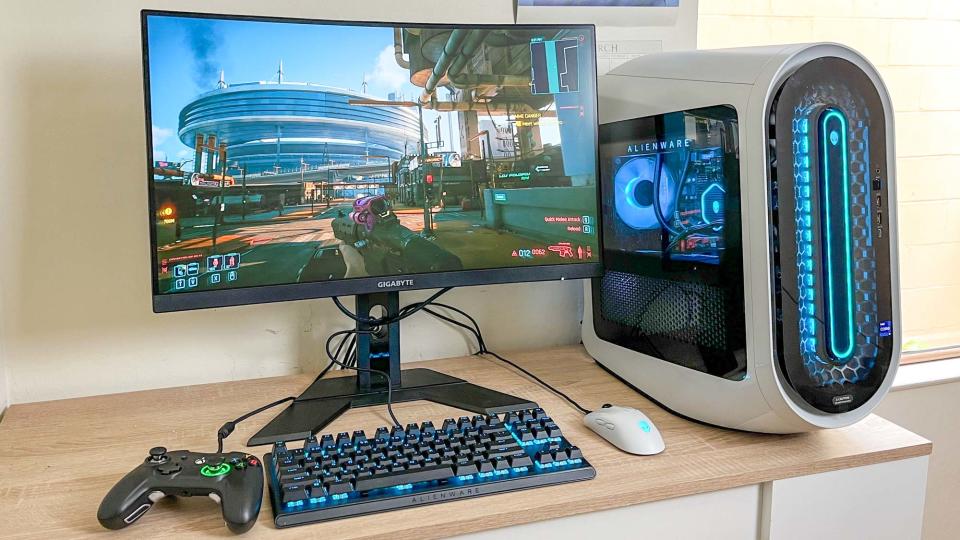 Alienware Aurora R15 review unit on desk, Cyberpunk 2077 playing onscreen