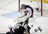 Pittsburgh Penguins' Brandon Sutter (16) puts the puck over Columbus Blue Jackets goalie Sergei Bobrovsky (72) and Fedor Tyutin (51) for a goal in the third period of a first-round NHL playoff hockey game in Pittsburgh Wednesday, April 16, 2014. The Penguins won 4-3, with Sutter's goal being the game-winner. (AP Photo/Gene J. Puskar)