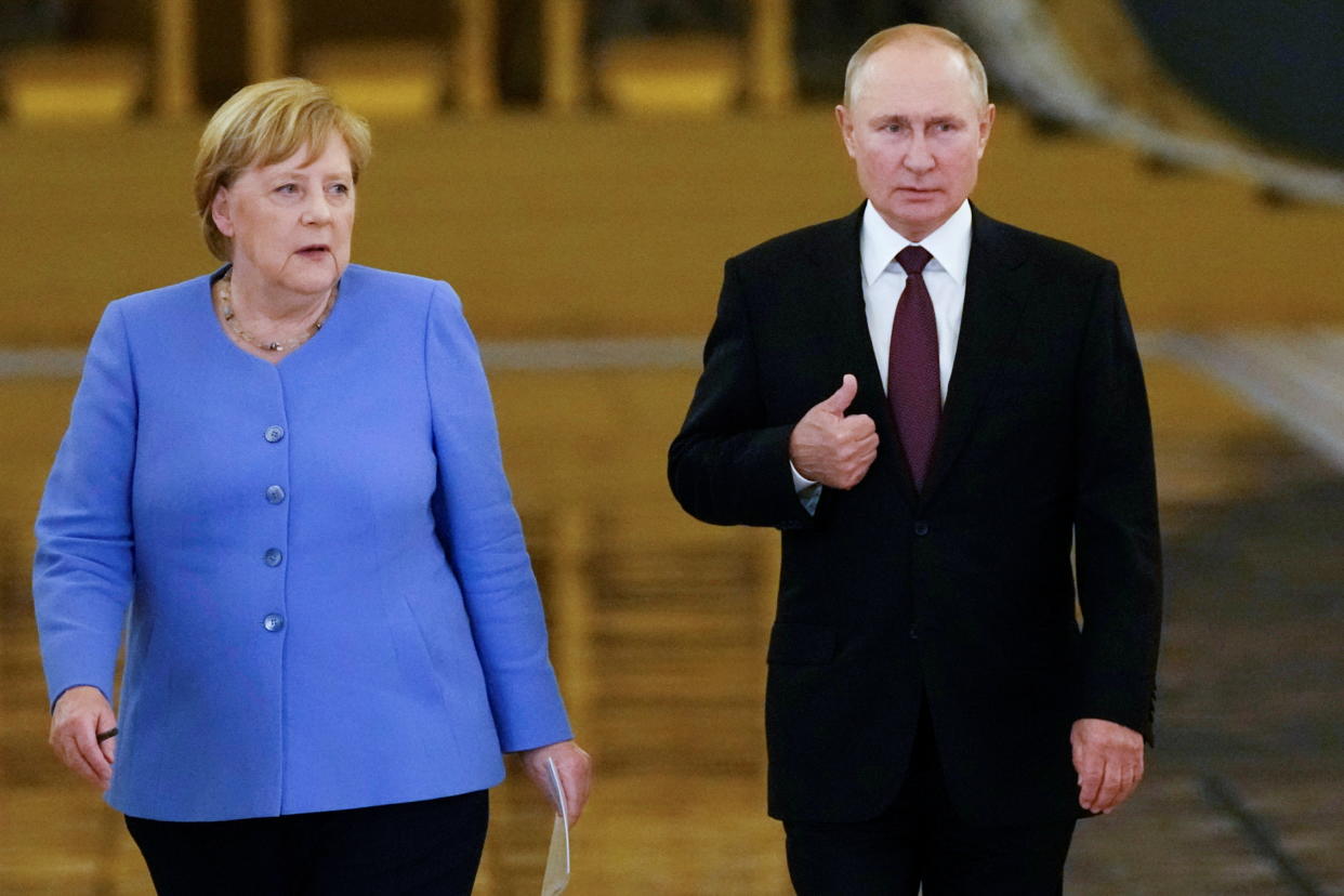 Russian President Vladimir Putin and German Chancellor Angela Merkel enter a hall during a news conference following their talks at the Kremlin in Moscow, Russia August 20, 2021. Alexander Zemlianichenko/Pool via REUTERS