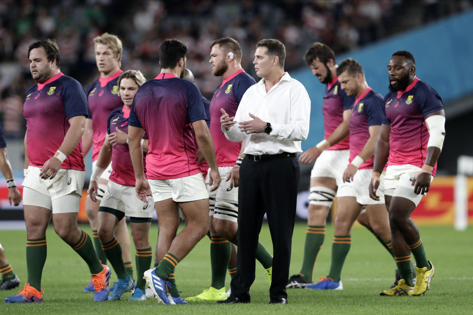 South Africa's coach Rassie Erasmus talks to his team before the Rugby World Cup quarterfinal match at Tokyo Stadium between Japan and South Africa in Tokyo, Japan, Sunday, Oct. 20, 2019. (AP Photo/Mark Baker)