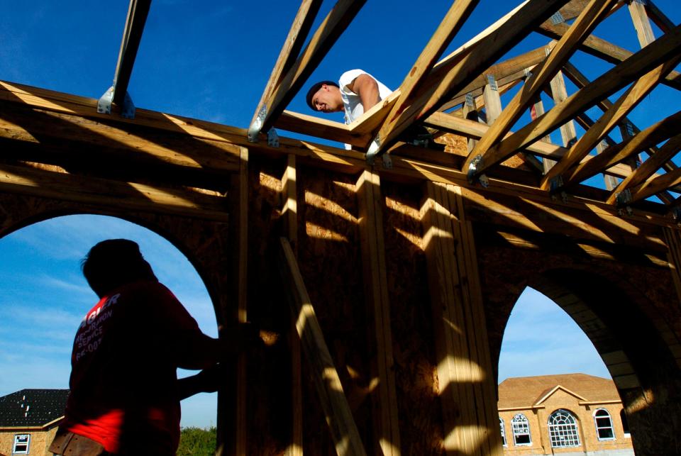 Carpenter Mark Montalto, bottom, helps Steven Meyers while constructing a home in Sebastian River Landing on Dec. 28, 2005. Sebastian, like other communities in the Treasure Coast, is experiencing a steady rate of growth with new neighborhoods being built.