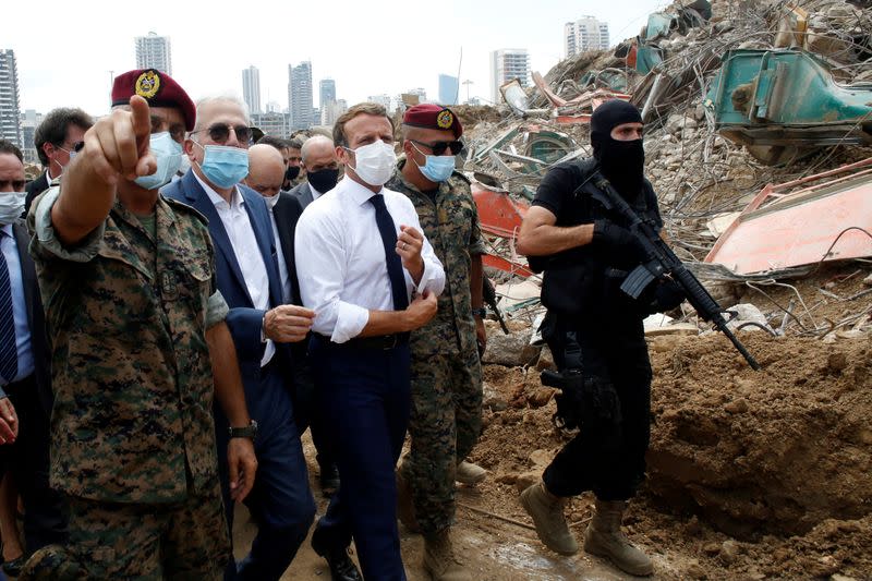 FILE PHOTO: French President Emmanuel Macron visits the devastated site of the explosion at the port of Beirut