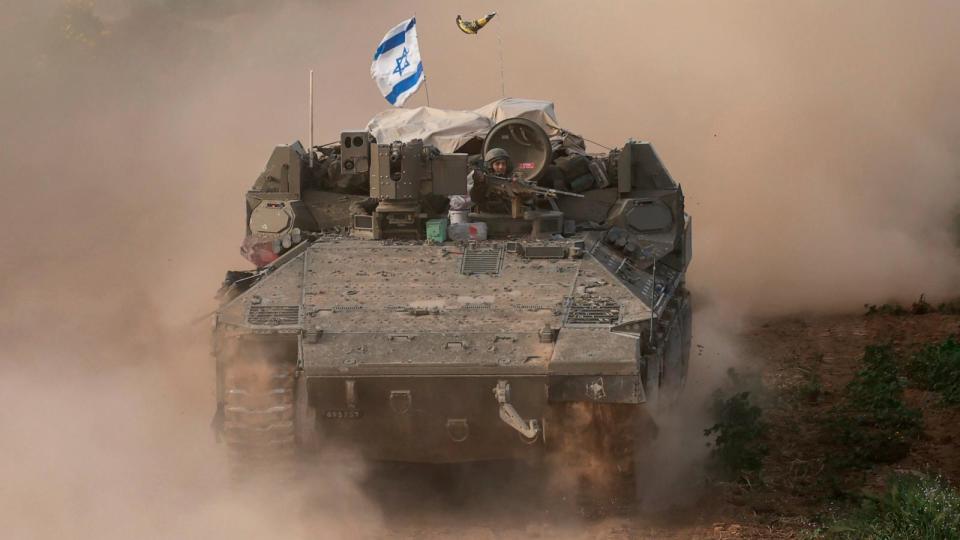 PHOTO: This picture taken from Israel near the border with the Gaza Strip shows an Israeli army soldier sitting on an armored personnel carrier as it moves out of Gaza, Feb. 26, 2024. (Menahem Kahana/AFP via Getty Images)