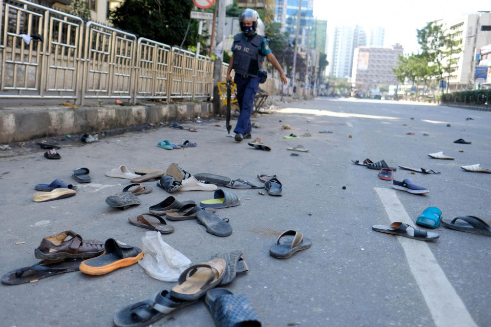 Footwear of protestors lie strewn on a road after clashes with police during a protest over an alleged insult to Islam, outside the country’s main Baitul Mukarram Mosque in Dhaka, Bangladesh, Friday, Oct. 15, 2021. Friday’s chaos in Dhaka followed reported incidents of vandalism of Hindu temples in parts of the Muslim-majority Bangladesh after photographs of a copy of the Holy book Quran at the feet of of a Hindu Goddess went viral on social media in a temple at Cumilla district in eastern Bangladesh. (AP Photo/Mahmud Hossain Opu, File)