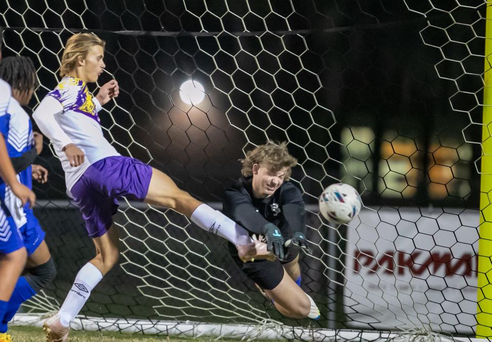 Belleview High School's Hunter Duncan (99) saves a goal blocking a kick from Lake Weir Skyler Courtney (18) during a boys soccer gamer as Belleview takes on Lake Weir at Belleview High School in Belleview, FL on Wednesday, November 29, 2023. [Alan Youngblood/Ocala Star-Banner]