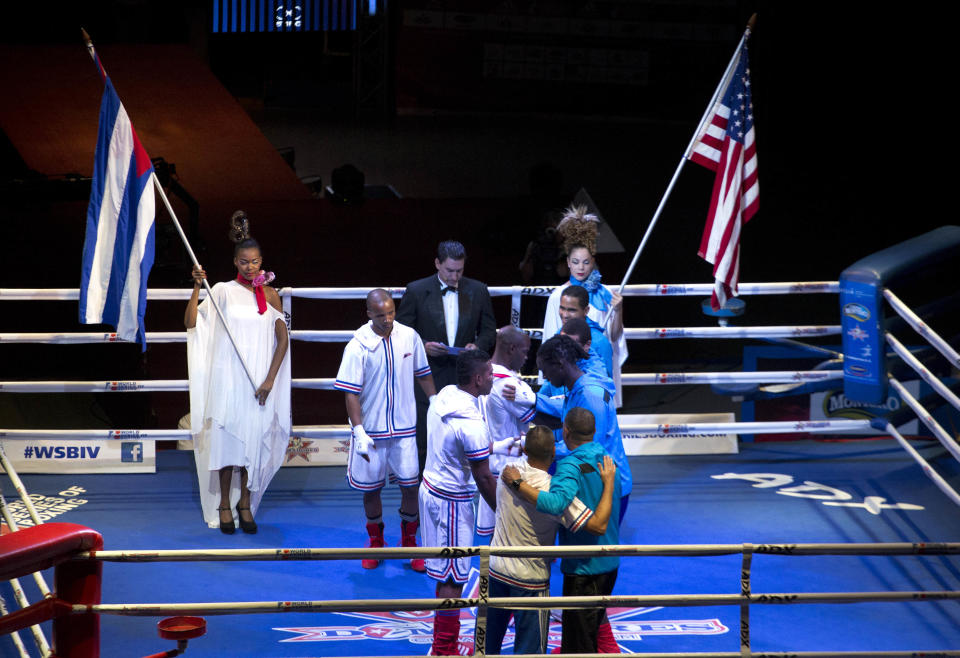 Cuban and U.S. boxers greet each other before the start of competition in Havana, Cuba, Friday, April. 4, 2014. Boxers from the U.S. and Cuba went glove-to-glove on Cuban soil for the first time in 27 years Friday in a semipro World Series of Boxing clash. (AP Photo/Ramon Espinosa)