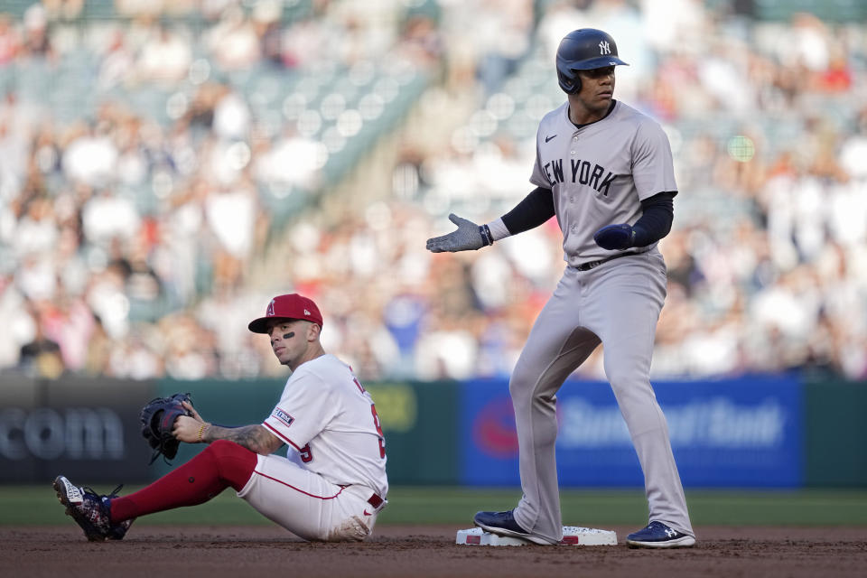 New York Yankees' Juan Soto, right, reacts after being called out for interfering with Los Angeles Angels shortstop Zach Neto, left, while trying to get back to second on a ball hit by Giancarlo Stanton during the first inning of a baseball game Wednesday, May 29, 2024, in Anaheim, Calif. Stanton was called out on the play and Soto was also called out on runner's interference. (AP Photo/Mark J. Terrill)