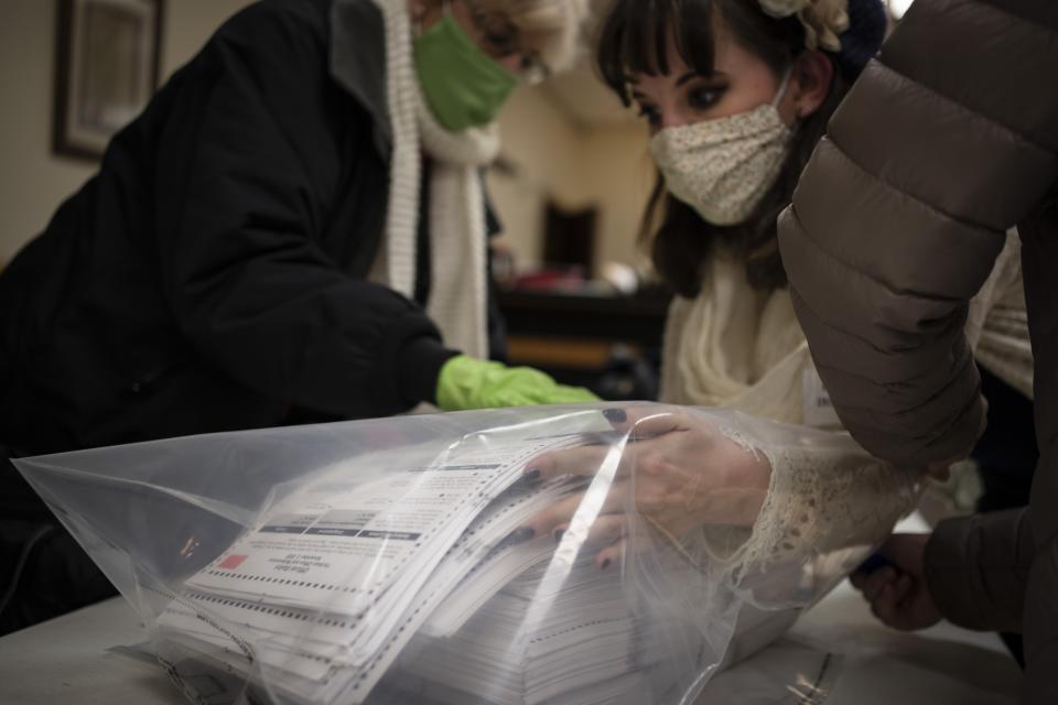 Election staff members pack ballots after polls closed at the Moose Lodge on Election Day, Tuesday, Nov. 3, 2020, in Kenosha, Wis. (AP Photo/Wong Maye-E)