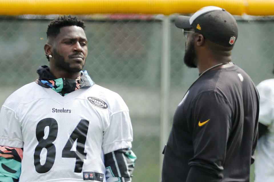 FILE - In this Aug. 7, 2018, file photo, Pittsburgh Steelers wide receiver Antonio Brown, left, talks with head coach Mike Tomlin at practice during NFL football training camp in Latrobe, Pa. Pittsburgh Steelers president Art Rooney remains confident in head coach Mike Tomlin despite a late-season collapse but is eyeing what to do with disgruntled wide receiver Antonio Brown. (AP Photo/Keith Srakocic, File)