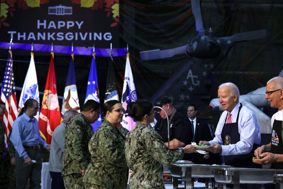 President Joe Biden helps serve service members and military families during a Friendsgiving dinner at the Norfolk Naval Station in Virginia on Nov. 19, 2023.