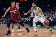 Boston Celtics forward Jayson Tatum (0) drives to the basket against Miami Heat guard Tyler Herro (14) during the first half of an NBA basketball game Wednesday, Nov. 30, 2022, in Boston. (AP Photo/Charles Krupa)