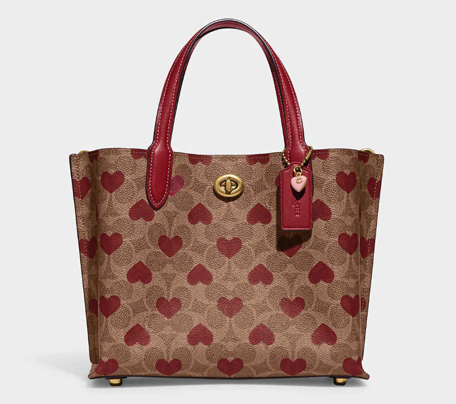 Willow Tote 24 In Signature Canvas With Heart Print. Image via Coach.